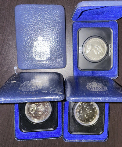 Lot of 4 different silvercolor nickel loonies proof in box OGP 1 bid per lot